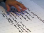 image of hand hovering over writing