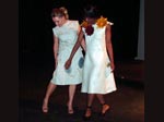 2 female models wearing white dresses