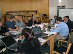 people gathered round a table working during a cluster workshop