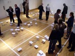 photo of people walking on a floor with a grid marked on it