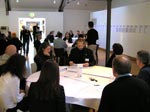 people sitting at tables in a workshop